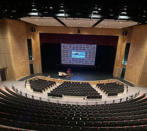 Auditorium seen from the balcony, a test pattern projected on the stage screen