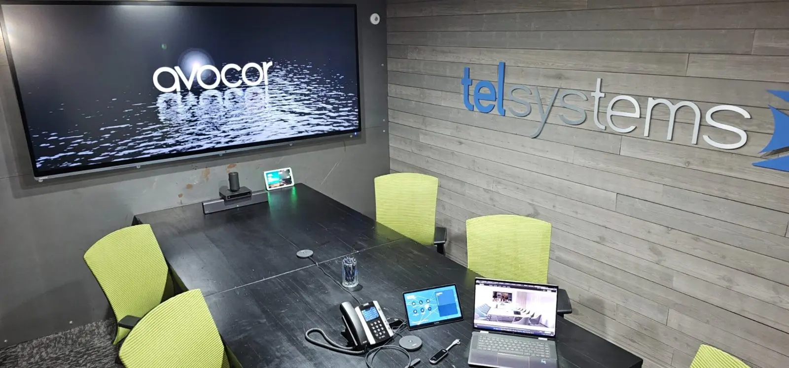 Small meeting room with a touchscreen display, conferencing bar and touch panel